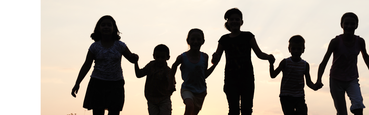 silhouette of children holding hands